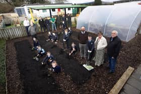 BIG GARDEN LAUNCH AT HOLLYBUSH PS. . . . .Pupils from Hollybush PS cutting the ribbon to officially open their new polytunnel and launch their new food growing garden project supported by Natural World Products (NWP). Included in photo are Colum Eastwood Foyle MP, Mark Durkan MLA, Colm Warren NWP, Feargal Friel, Acting Principal, Cahir O'Connor, Vice Principal, Gareth Lamrock, ECO Schools Education Officer, Allan Bogle Acorn Farm, Sharon McMaster Community Outreach Manager and Horticulturist for NWP, Patricia McCormick, After-School Garden Club Facilitator, Andy McDermott, school caretaker and board of governors representatives Paul Kirby and Angela Dobbins. (Photos: Jim McCafferty Photography)