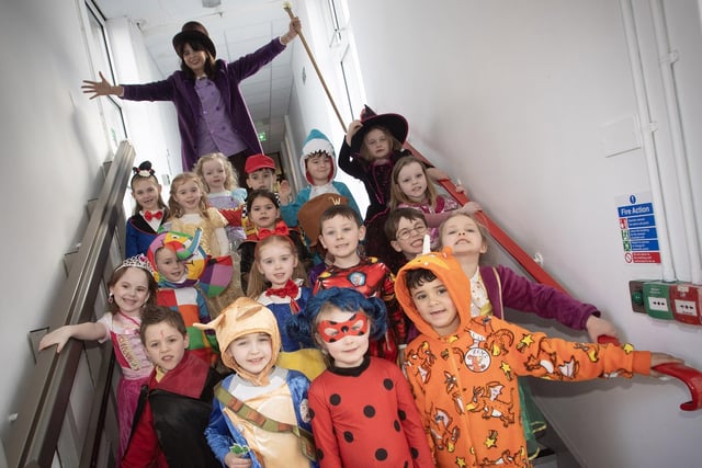 Mrs Doorish and Primary 1 pupils getting into character for World Book Day at Steelstown PS.