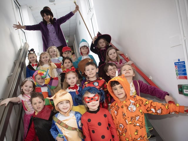 Mrs Doorish and Primary 1 pupils getting into character for World Book Day at Steelstown PS.