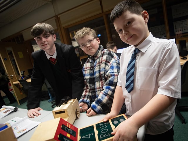 St. Joseph's student Cahir Irvine showing Ethan Divin, St. Anne's PS and Christian Roberts, Rosemount PS around one of the departments at the school's open night on Tuesday.