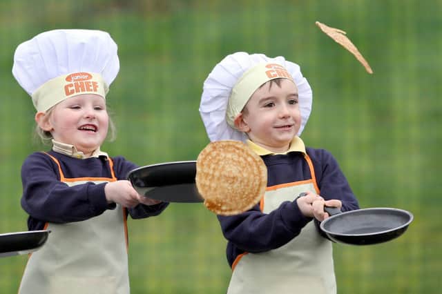 Pupils at Gaelscoil Eadain Mhoir flipping pancakes in 2012.