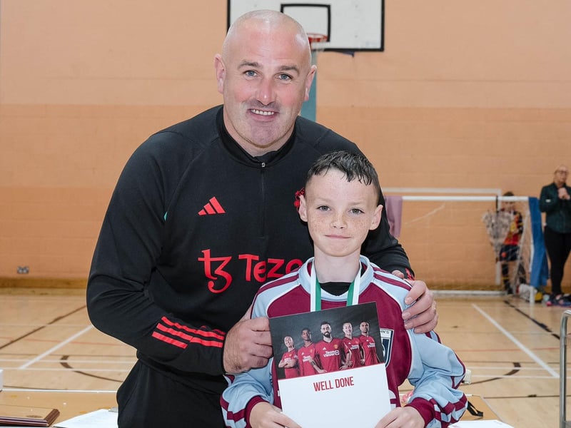 Lorcan Duffy collecting one of the Top Performer awards from Stephen Parkhouse, Manchester United Foundation at St. Joseph's Boys' on Thursday.