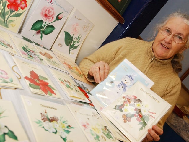 Mary Putt with her selection of hand painted cards and pictures. (0612PG53) : Christmas in Inishowen in 2005.