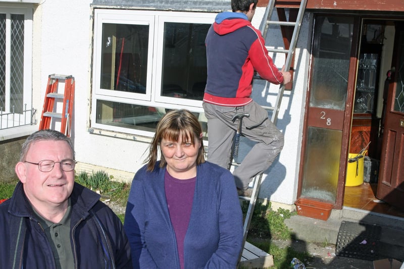 Councillor Tony Hassan pictured with Moyola Drive resident Martina Doherty as work was carried out on the replacement of windows in the Shantallow area.