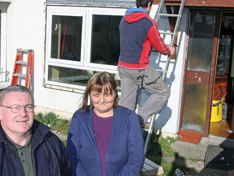 Councillor Tony Hassan pictured with Moyola Drive resident Martina Doherty as work was carried out on the replacement of windows in the Shantallow area.