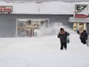 A resident leaves a local corner store in Buffalo, New York, on December 26, 2022, as many major grocery stores remained closed. - Emergency crews in New York were scrambling on December 26, 2022, to rescue marooned residents from what authorities called the "blizzard of the century," a relentless storm that has left dozens dead in the state and is causing US Christmas travel chaos. (Photo by Joed Viera / AFP) (Photo by JOED VIERA/AFP via Getty Images)