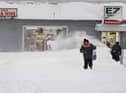 A resident leaves a local corner store in Buffalo, New York, on December 26, 2022, as many major grocery stores remained closed. - Emergency crews in New York were scrambling on December 26, 2022, to rescue marooned residents from what authorities called the "blizzard of the century," a relentless storm that has left dozens dead in the state and is causing US Christmas travel chaos. (Photo by Joed Viera / AFP) (Photo by JOED VIERA/AFP via Getty Images)