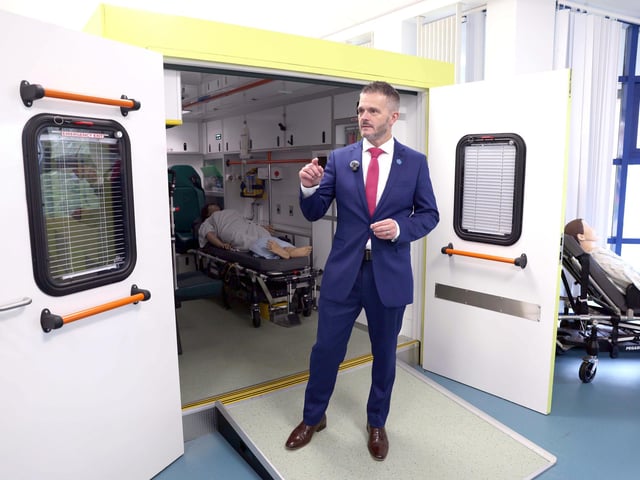 Health Minister Robbie Butler MLA visiting a simulated ambulance at Derry's Magee College campus.