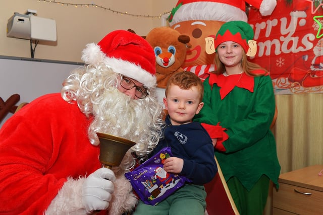Malkai pictured with Santa and his helpers at the Galliagh Community Christmas Craft Fair and Wonderland on Saturday afternoon.  Photo: George Sweeney