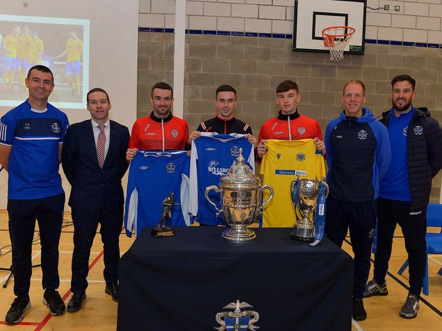 Derry City players Michael Duffy, Jordon McEneff and Liam Mullan pictured with St Columb's College PE staff Eamon Burns, Tyan Horner, James Green and Mark Scoltock during a visit to the school, with the FAI Cup on Monday. Photo: George Sweeney. DER2247GS - 19