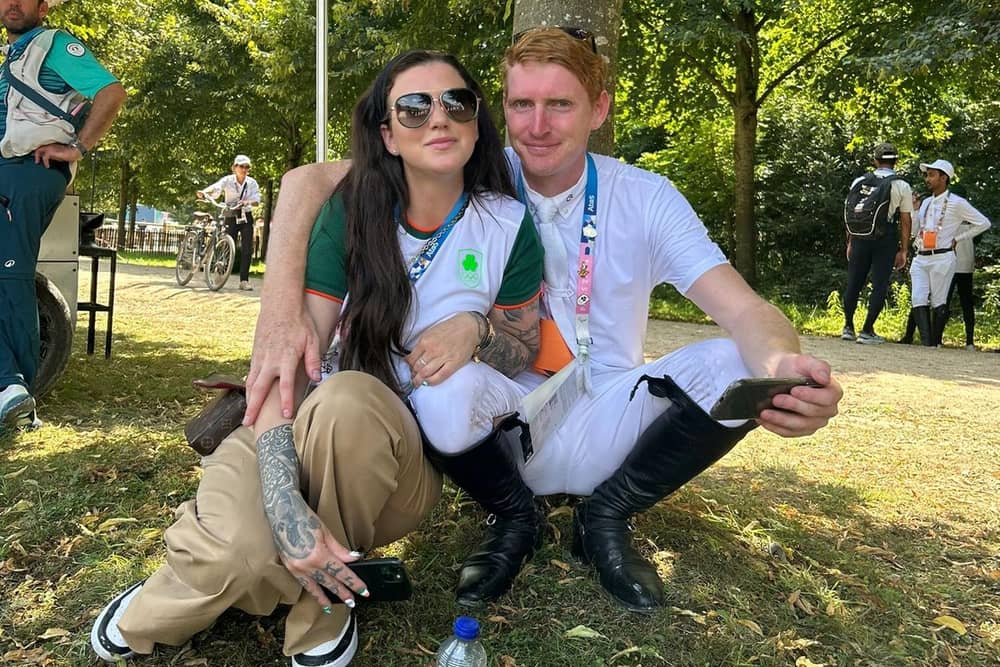 Derry showjumper Daniel Coyle relaxes with his partner, Catriona O'Hagan, after his clear round at the Paris Olympics on Thursday morning. (Photo: Eamonn McGowan)