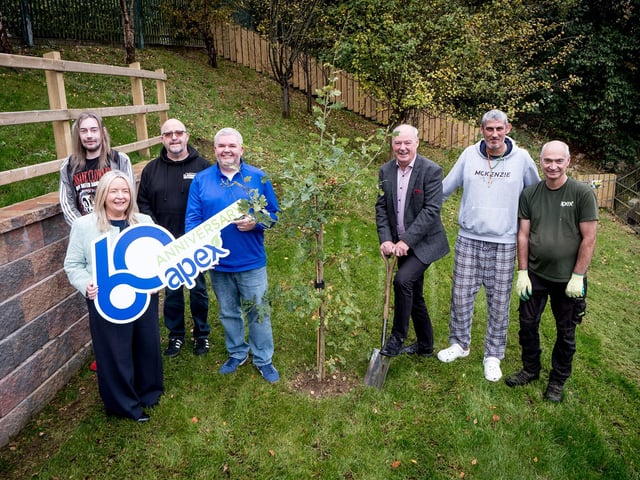 A native tree was planted at The House in The Wells in Derry by Apex Chairperson, Liam Hannaway, accompanied by Chief Executive Sheena McCallion. Also pictured, House residents Harry and Charlie; Manager, Andy Bonner; Deputy Manager, Patrick Downey and Martin Breslin from Apex's estates team.