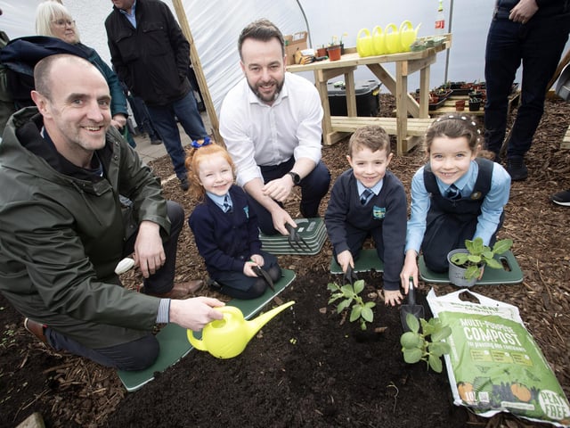 GREEN FINGERS FOR FOYLE MP. . . .Foyle MP Colum Eastwood was at Hollybush Primary School on Friday last to help out on the official launch of the school's new peat free, no dig, school garden, courtesy of Natural World Products using New Leaf Compost. NWP  also gifted the school a polytunnel and potting benches. Included are pupils Alannah, Liam and Cara. On left is Mark Durkan, MLA. (Photo: Jim McCafferty Photography)