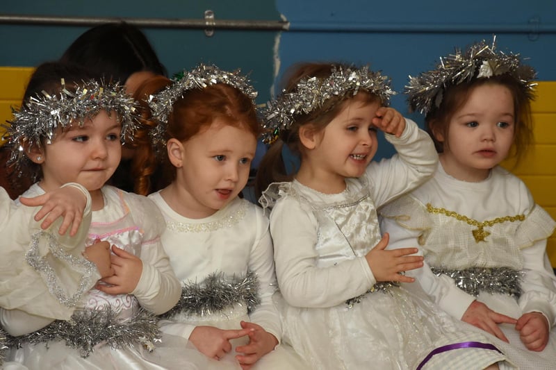 The angels sang a song to share the good news during the Long Tower PS Infants Christmas Nativity - Ava, Harley, Remy, Harper.
