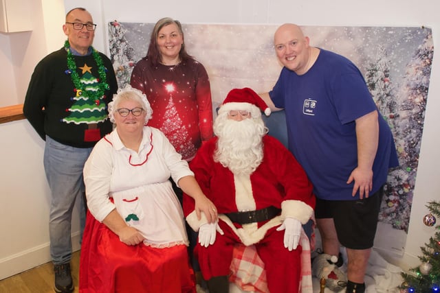 Staff with Santa and Mrs Claus, from left to right – Mark Leach, Clare-Ellen Duddy, and Brian Hasson.