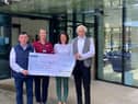 Caroline, on behalf of her father Sean O’Kane is pictured with Noel Donaghy, Benedy Community Association Limited presenting the cheque to North West Cancer Centre.