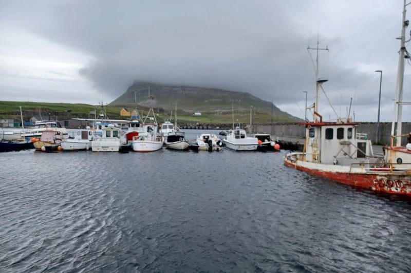 A view of the cloud-topped mountain of Høgoyggj from Nólsoy harbour. The island of Nólsoy is short ferry trip from Tórshavn