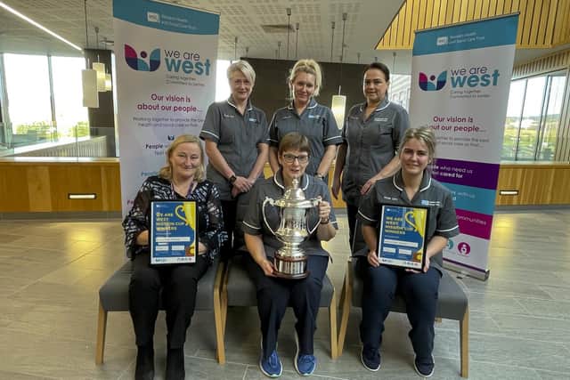 Western Trust Chairman Dr Tom Frawley and Western Trust Chief Executive Neil Guckian pictured presenting the first winners of the Western Trust's new Mission Cup Award to the Homecare Team who provide a caring service covering the entire Western Trust area 365 days a year.