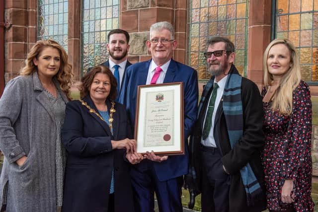 Derry City and Strabane District Council Mayor, Councillor Patricia Logue with Jon McCourt and his family, who has been awarded the freedom of Derry City and Strabane following a ceremony in The Guildhall. Jon has campaigned tirelessly for the victims of Institutional abuse. Included are his daughters, Cheryl Boylan and Lisa McCourt, son, Calvin and Jon’s brother Eddie. Picture Martin McKeown. 19.12.23