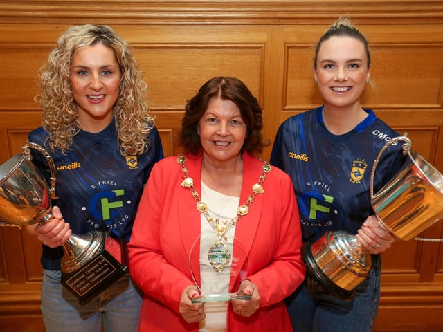 The Mayor of Derry and Strabane, Councillor Patricia Logue presents a civic gift to mark the reception to joint captains Aoife McGough and Ciara McGurk.