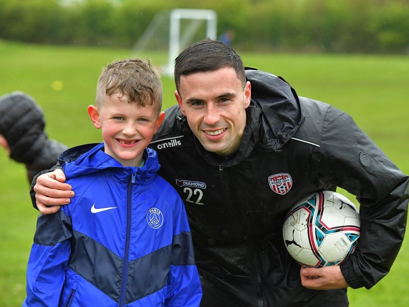 Derry City midfielder Jordan McEneff is all smiles with this young lad coaching during the Easter Soccer Camp held at Broadbridge Primary School. Picture: George Sweeney. DER2315GS – 140