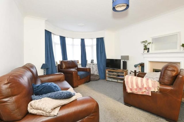 The main room on the ground floor of the property is this open-plan lounge/diner. It boasts a gas fireplace with surround, a fitted carpet and a uPVC double-glazed bay window overlooking the front.