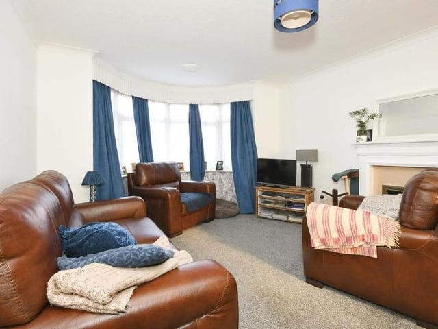 The main room on the ground floor of the property is this open-plan lounge/diner. It boasts a gas fireplace with surround, a fitted carpet and a uPVC double-glazed bay window overlooking the front.