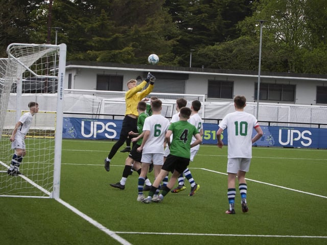 Grosvenor College goalkeeper Watson Kingham clears this danger from a St. Joseph’s corner on Friday.