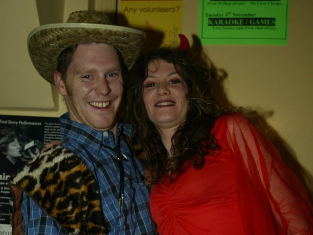 Cowboy Darren McGonagle gives his devilish wife Kerry a leg up.  (0311JB63):20 YEARS ON: Halloween celebrations in Derry in 2003