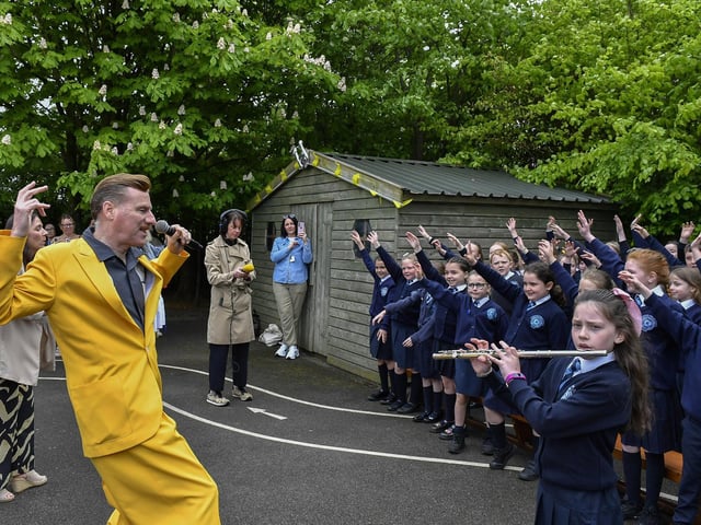 Ian Clarkson from the Jive Aces singing “The Derry Jazz Song” with the Rosemount Primary School choir and band on Thursday morning. Photo: George Sweeney