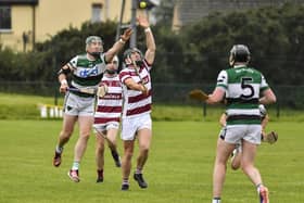 Na Magha’s Breandan Quigley and Eanna O’Caiside of Slaughtneil contest a loose sliothar. Photo: George Sweeney