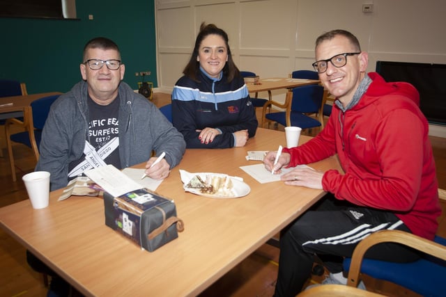 Colum Millar and Denis McLaughlin fill in a survey with the assistance of Aisling Hutton, after taking part in Saturday’s Men’s Health Day at the Old Library Trust, Creggan.