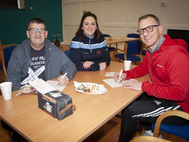 Colum Millar and Denis McLaughlin fill in a survey with the assistance of Aisling Hutton, after taking part in Saturday’s Men’s Health Day at the Old Library Trust, Creggan.