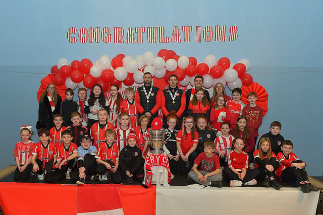 Derry City defenders Daniel Lafferty and Ciaran Coll pictured with Mr Conaghans P7 class and the FAI Cup at St Eithnes Primary School on Wednesday morning. Photo: George Sweeney.  DER2246GS  089