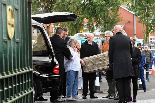 A wicker coffin, containing the remains of journalist and activist Nell McCafferty, is brought to the Long Tower Church for Requiem Mass on Friday afternoon. Photo: George Sweeney