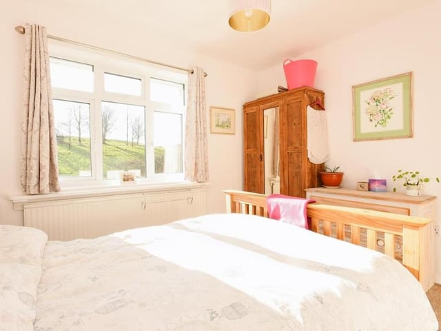 The second bedroom has a touch of elegance about it. With its carpeted floor and radiator, and space for a wardrobe, it has views facing the back of the property.