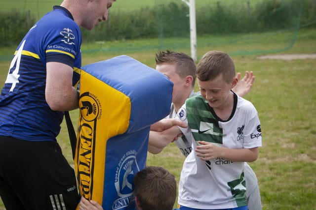 Conor Gartland, Burt and Donegal senior hurler, just about stays on his feet as three young Burt players try out the crash bag on Sunday.