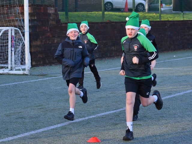 St. Joseph's Boys School students Brandon, Kayden and Rory make their way around the track on Tuesday.