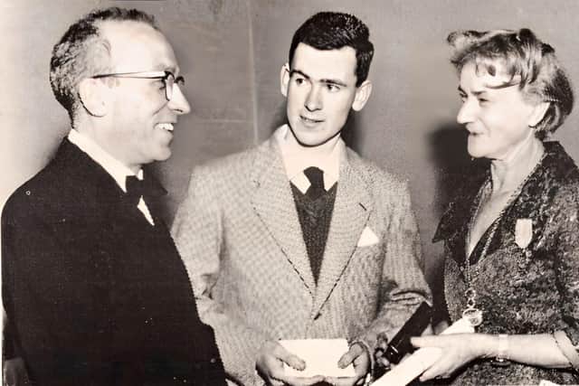 Fr Mullan pictured with his late mother as a young student of St Columb’s College receiving a prize for his historical studies.