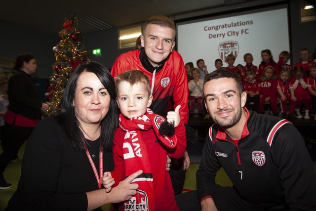 Mrs. Devine and her nephew Aidan pictured with the Derry players.