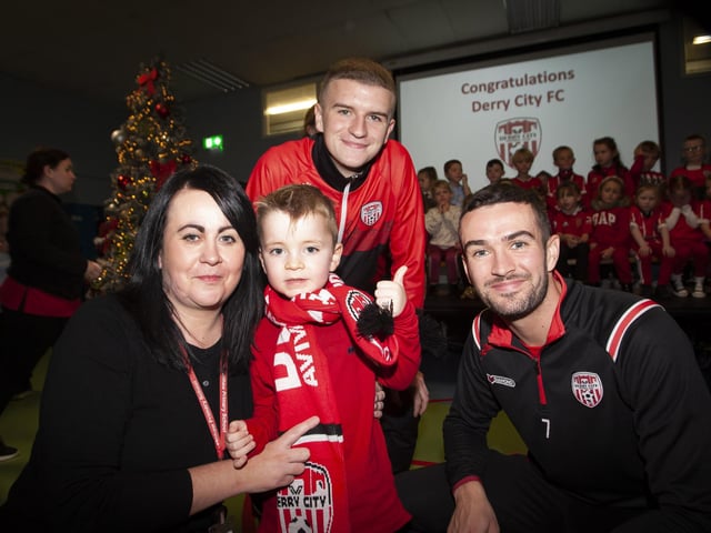 Mrs. Devine and her nephew Aidan pictured with the Derry players.