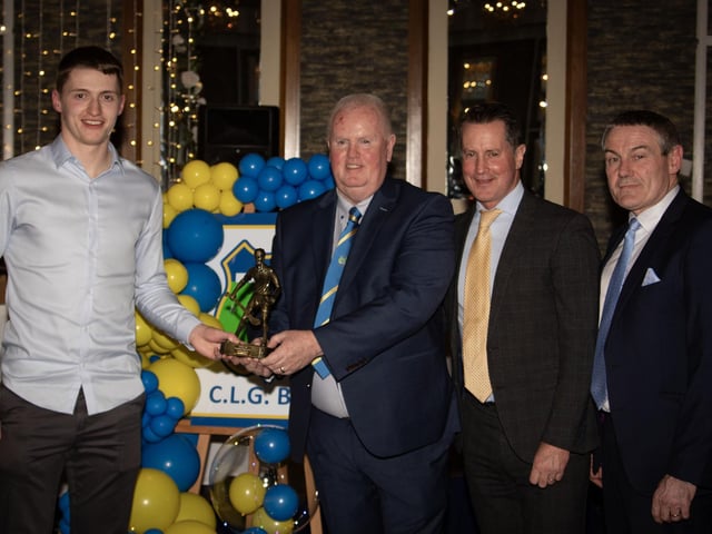 Liam Og McKinney, Nicky Rackard Player of the Year 2024 receives his trophy from Liam Gallagher, Club Chair. Included on right are Ciaran McLaughlin, former Ulster President, and Cormac Hartnett, County Board Hurling Officer.