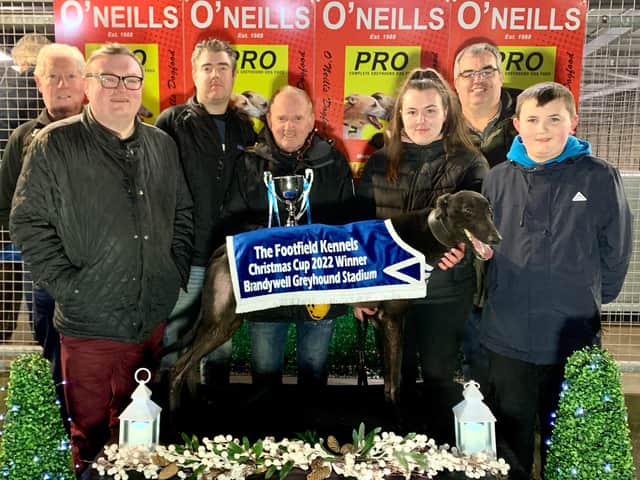 Kearney's Galaxy who won the Kevin O’Kane Sprint in 16.80 with (from left) Darren & Dean Toland, Johnny Carlin, Kealan O’Kane, Shane Talbot, Kevin O’Kane & Orla Wray.