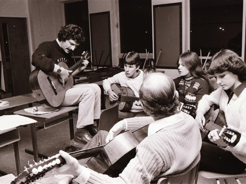 Guitar tutor Eamon Toland (on left) and musicians enjoying a session at Carnhill High School.