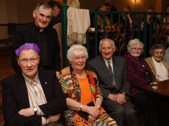 From left, Tom Harkin, Father Patrick McGoldrick, Sarah Anne McLaughlin, Liam McDaid, Anna Crumlish, and Brigid McDaid. (0912PG37) :Christmas parties for Derry's senior citizens in December 2003