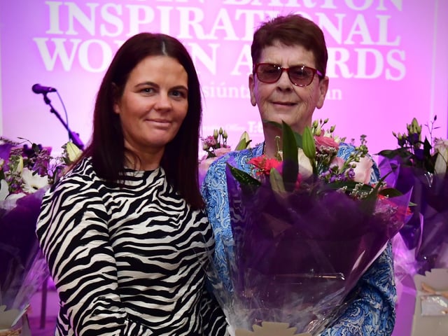 Jean Rodgers receiving her presentation from Aine Doherty, daughter of Roisin Barton.