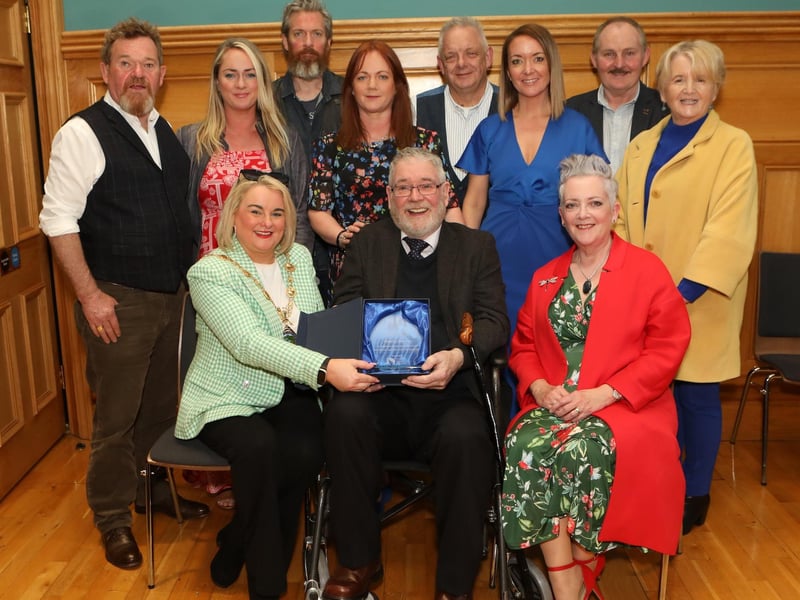 Mayor Sandra Duffy making a presentation to sculptor Maurice Harron, in recognition of his contribution as an art educator and artist in the City and District at a civic reception held in the Guildhall. Included are family and friends. (Photo - Tom Heaney, nwpresspics)