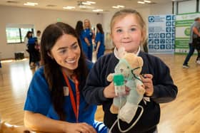 Student Jasmine Gallagher helps Sophie Wilson with her teddy’s oxygen supply