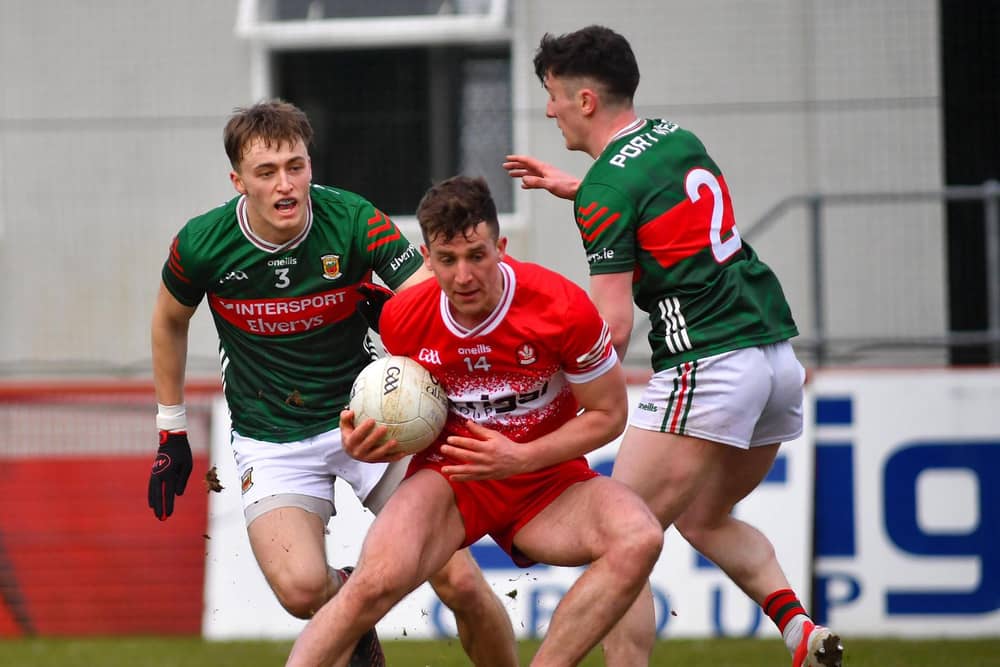Derry's Shane McGuigan holds off Mayo's Donnacha McHugh and Jack Coyne. Photo: George Sweeney