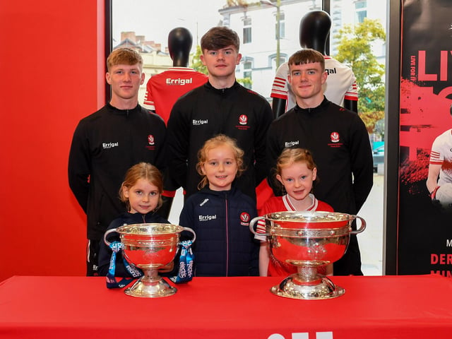 Emily Kelly, Noleen Kelly and Eden Davey pictured with members of Derry's All-Ireland Minor Champions team at O'Neill's Superstore last week. Photo: George Sweeney